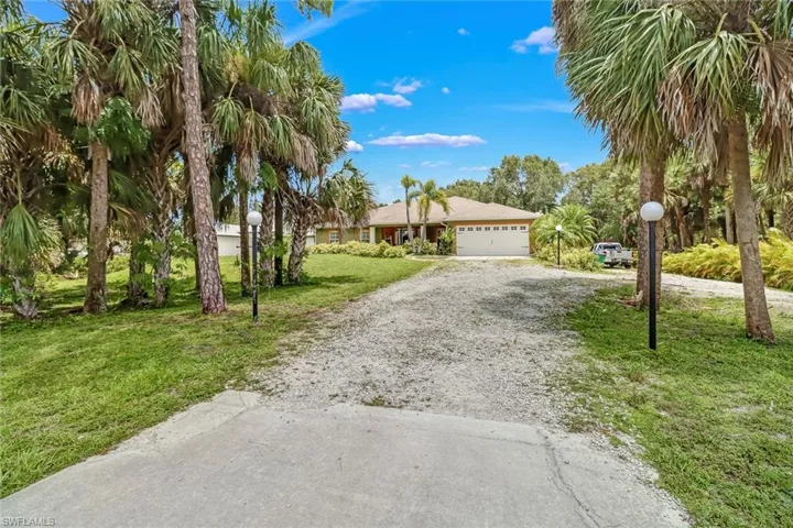 Long driveway with an additional driveway on the side of the home