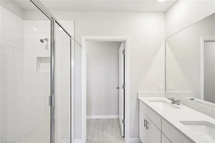Bathroom featuring vanity and a shower with shower door