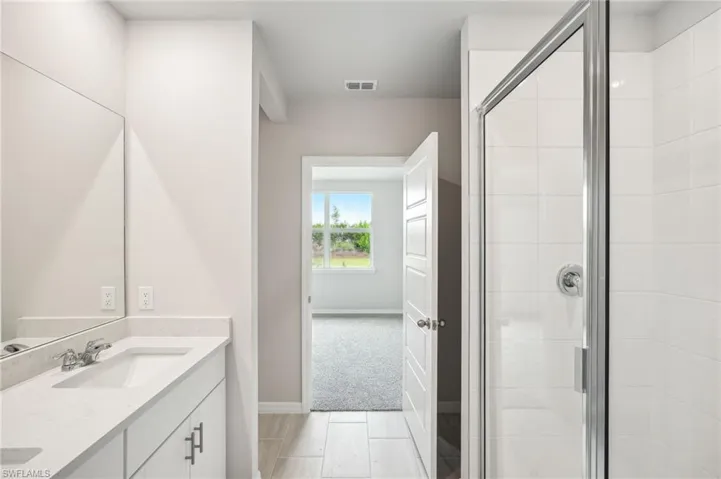 Bathroom with vanity and an enclosed shower