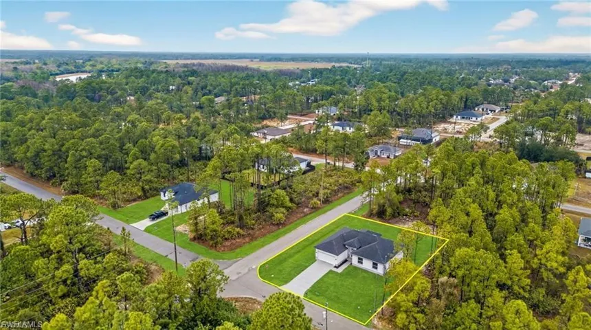 View of property location featuring property parcel outlined and a forest