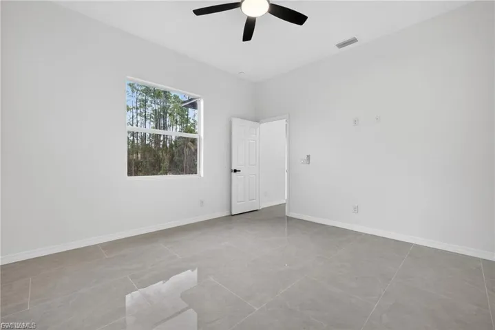 Unfurnished room featuring baseboards and a ceiling fan