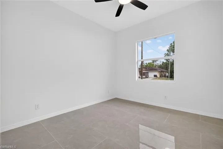 Spare room featuring baseboards and a ceiling fan