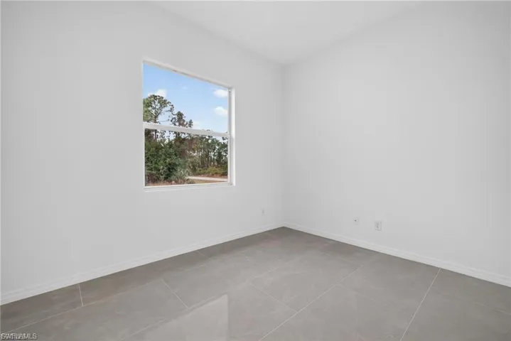 Unfurnished room featuring baseboards