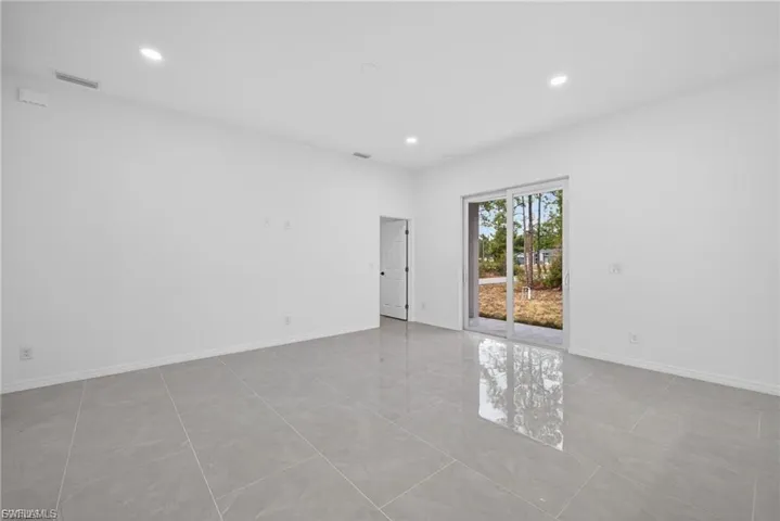 Spare room featuring recessed lighting and baseboards