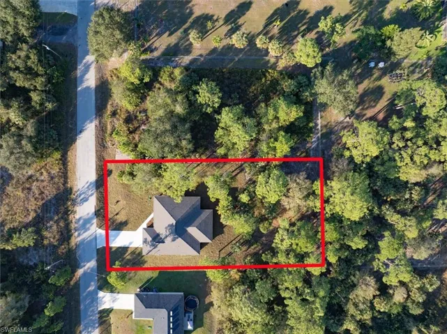 Overhead view. The lot behind the home is fenced with chain link