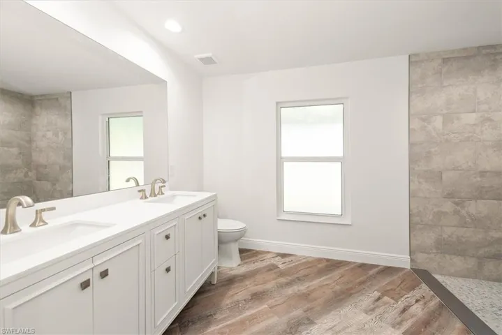 This bath features lots of storage and also has a privacy glass window so you can allow more natural light into the bathroom.