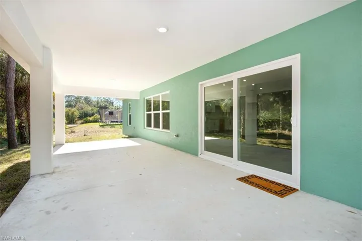 Large lanai with can lighting. The sliders are very heavy duty featuring impact double pane insulated glass. No storm shutters to worry about which is much better to not have to block the ingress egress.