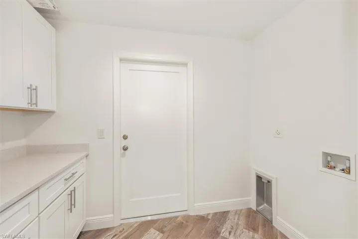The laundry room is just off the kitchen and offers pantry storage.