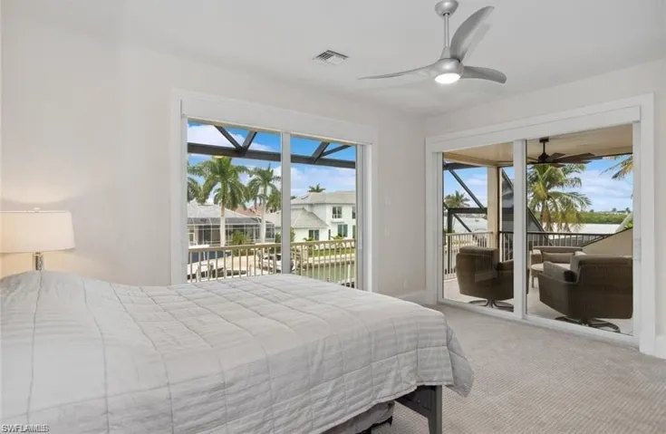 #4 Bedroom upper level featuring visible vents, baseboards, a sunroom, access to exterior, and carpet