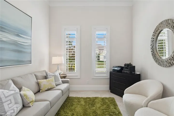 Living area featuring baseboards and carpet flooring