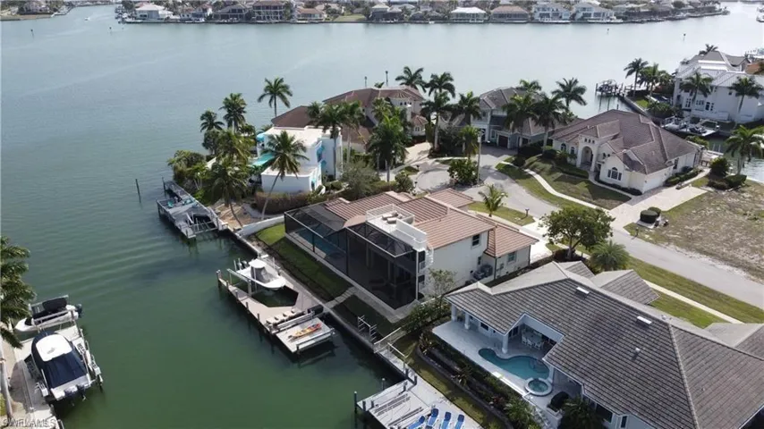 Birds eye view of property with a water view and a residential view