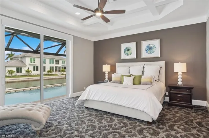 Bedroom featuring baseboards, coffered ceiling, a ceiling fan, access to exterior, and carpet floors