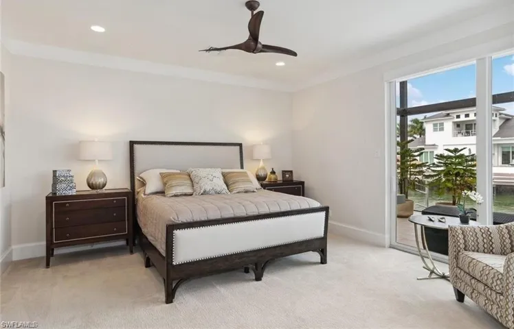 #2 Bedroom Main level featuring crown molding, recessed lighting, light carpet, access to outside, and baseboards