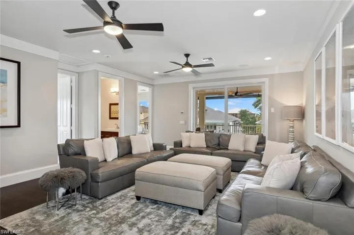 Family Room upper level with baseboards, visible vents, wood finished floors, and ornamental molding