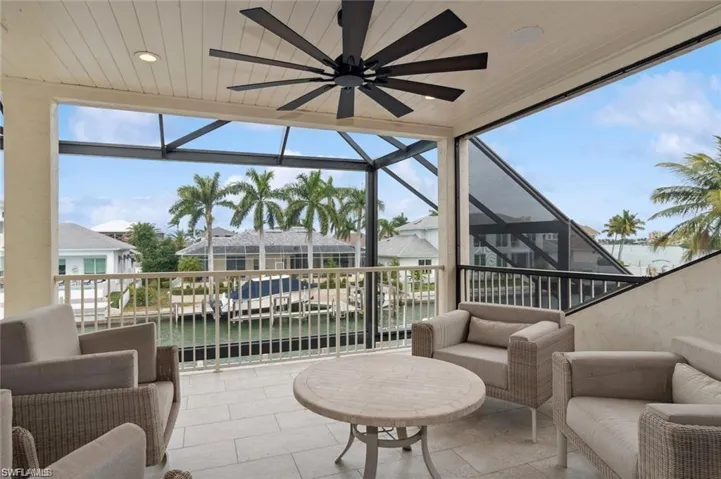 Upper Lanai, screened in  featuring a healthy amount of sunlight, wooden ceiling, a water view, and a ceiling fan