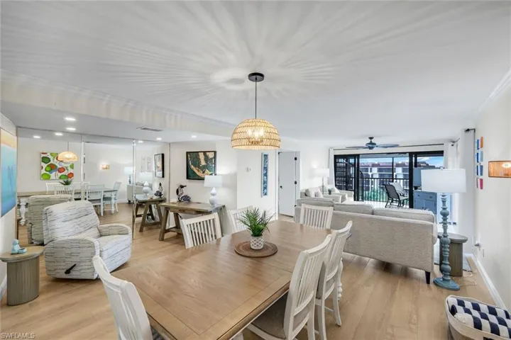 Dining space featuring light wood-style flooring and crown molding