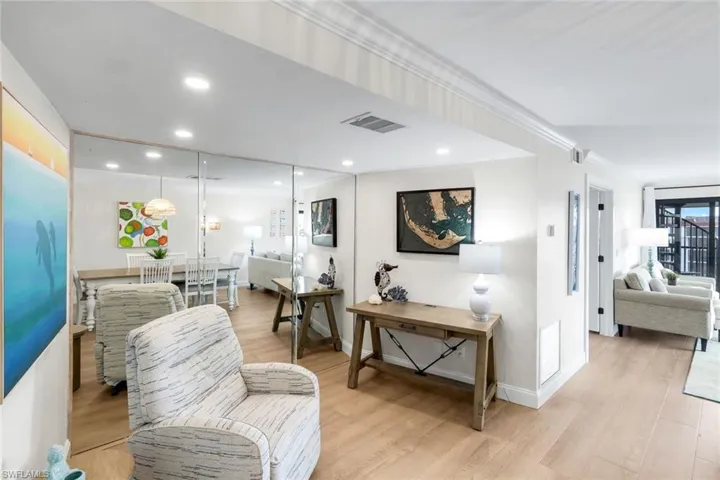 Hall with light wood-style flooring, recessed lighting, and crown molding