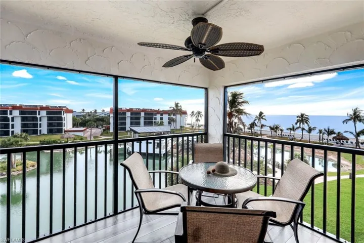 Balcony featuring a water view and ceiling fan