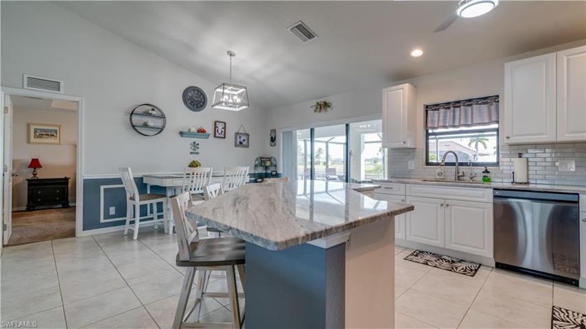 Beautiful cabinetry, updated lighting, marble countertops, modern tile backsplash!