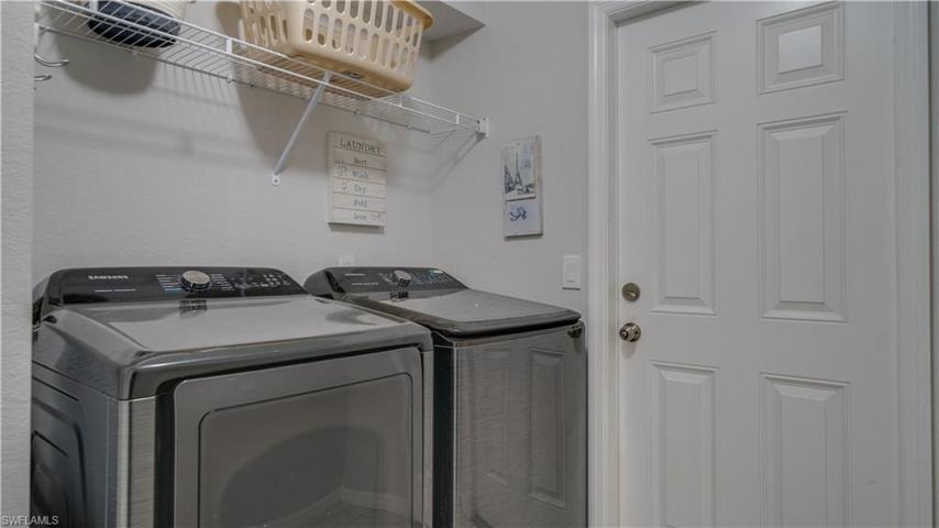Interior laundry room leading out to garage. There is also a linen / storage closet in this room.