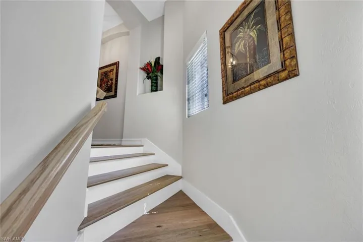 Staircase featuring a fireplace and wood-type flooring