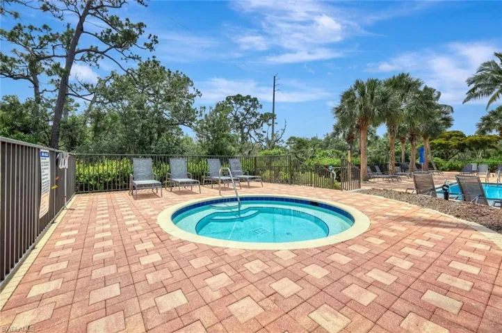 View of swimming pool with a community hot tub and a patio