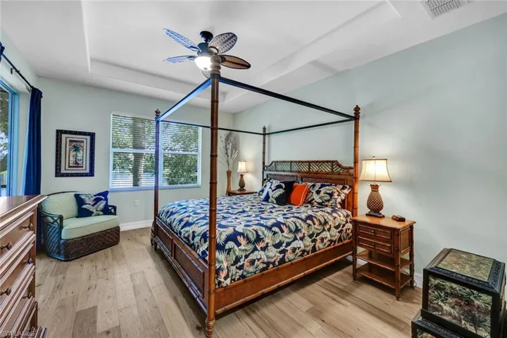 Bedroom with light hardwood / wood-style floors and ceiling fan