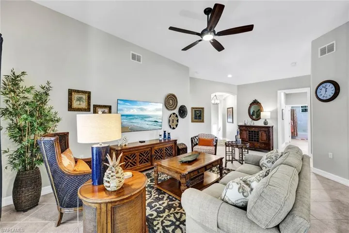 Living room with tile flooring and ceiling fan