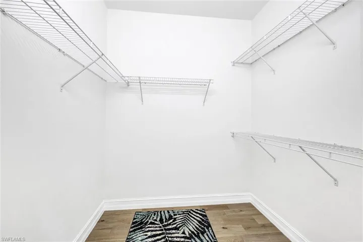 Spacious closet featuring hardwood / wood-style flooring