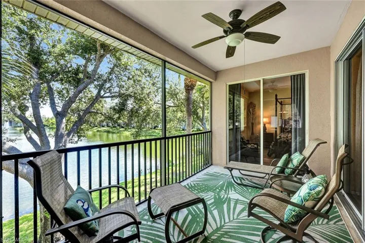Sunroom / solarium featuring a water view and ceiling fan