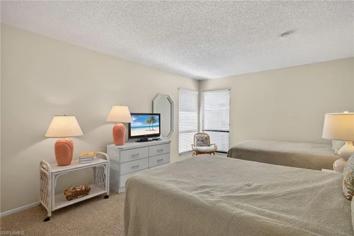 Bedroom with carpet flooring and a textured ceiling