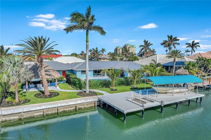 View of dock featuring a yard and a water view