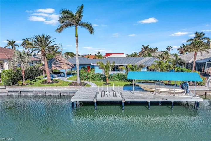 Dock area with a yard and a water view