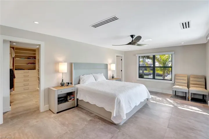 Bedroom with a spacious closet and ceiling fan