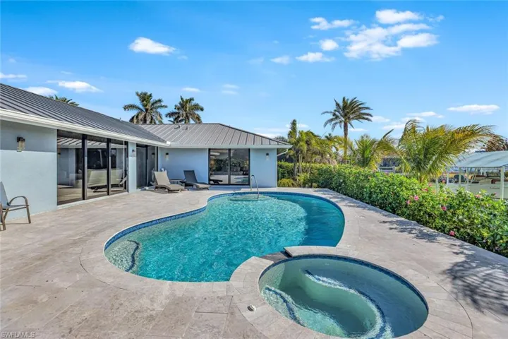 View of swimming pool featuring an in ground hot tub and a patio