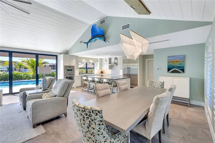 Dining room featuring high vaulted ceiling and wooden ceiling