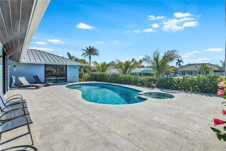 View of pool featuring a patio area and an in ground hot tub
