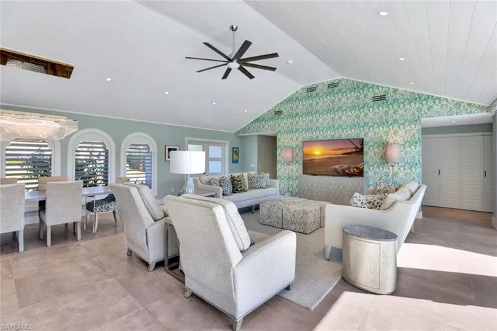 Living room featuring ceiling fan, lofted ceiling, and wood ceiling