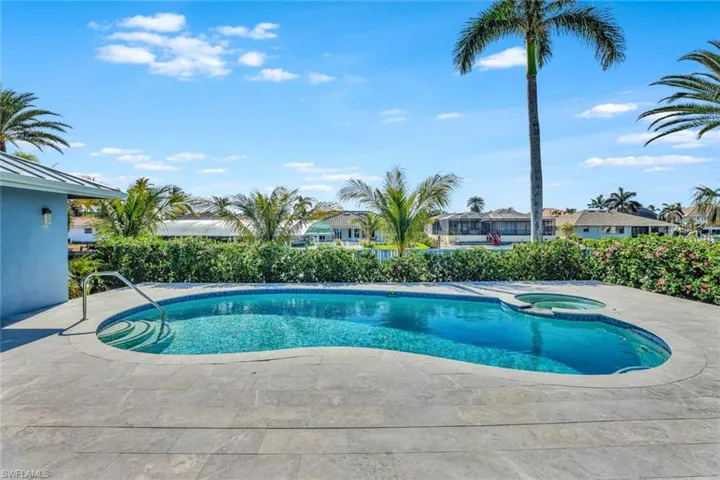 View of swimming pool with an in ground hot tub and a patio area