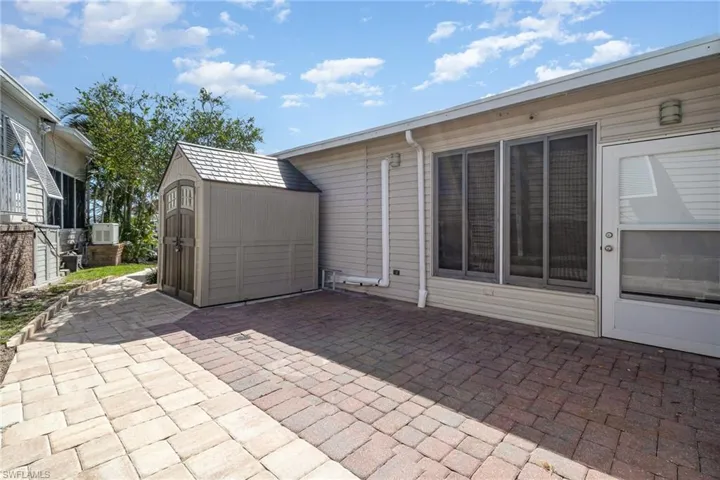 Side Patio and storage shed. Wraps around to the rear dock and patio