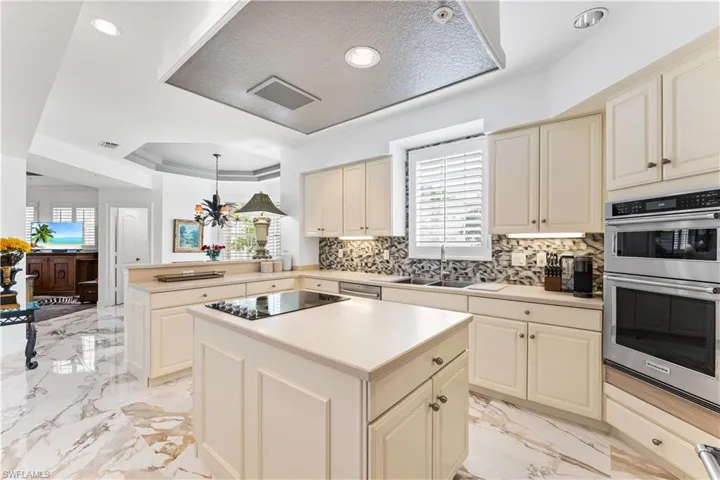 Your kitchen boast an island, cooktop, all new appliances, tray ceiling, underlighting and backsplash!