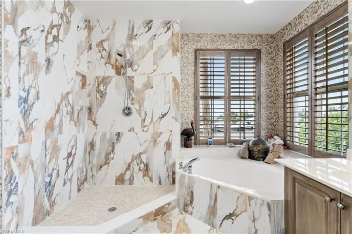 Your primary ensuite bath has a separate soaking zen tub where you have even more views of the marina and river! An oversized walk in shower with floor to ceiling tile.
