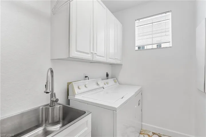 Nice storage and sink in laundry room.