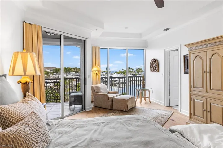 Yoour primary bedroom has stunning views of the marina and access to your lanai.