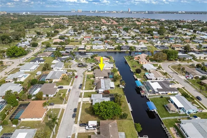 View of property location featuring a nearby body of water and nearby suburban area