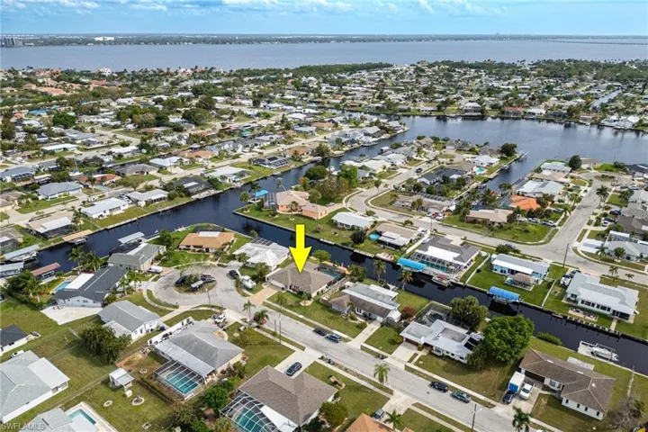 Aerial view of property's location featuring nearby suburban area and a nearby body of water