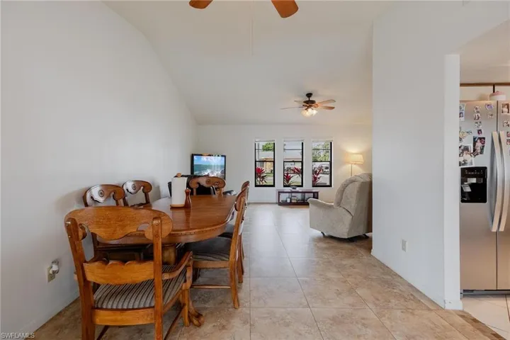 Dining space with a ceiling fan and light tile patterned floors