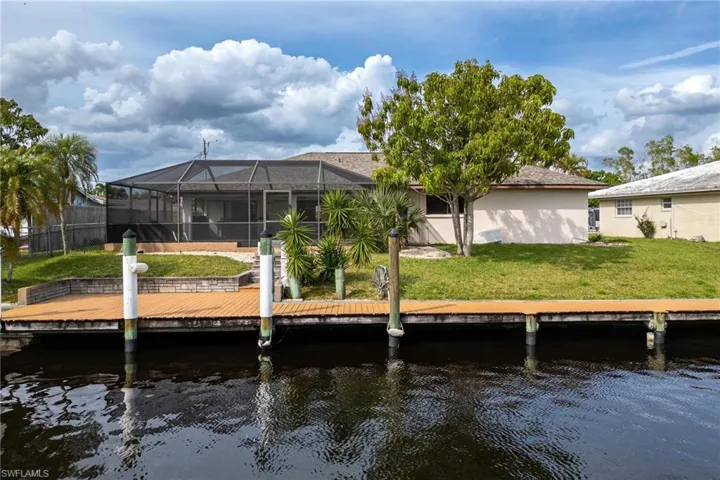 Dock featuring a sunroom, glass enclosure, and a water view
