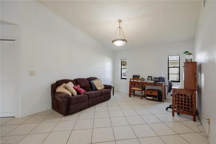 Living room featuring a desk and light tile patterned floors