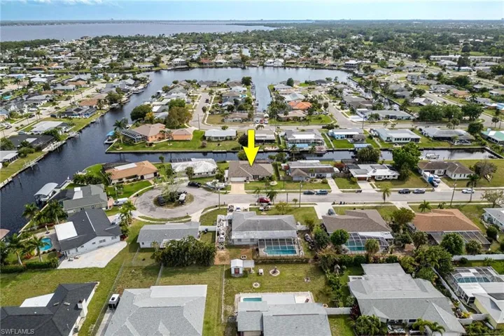 Aerial view of property's location featuring nearby suburban area and a nearby body of water